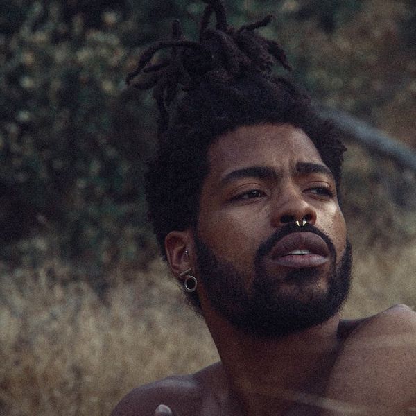 A person meditating calmly with a serene expression.